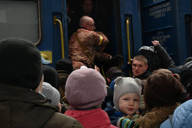 Residents of Kyiv attempting to flee the city crowd onto trains heading West