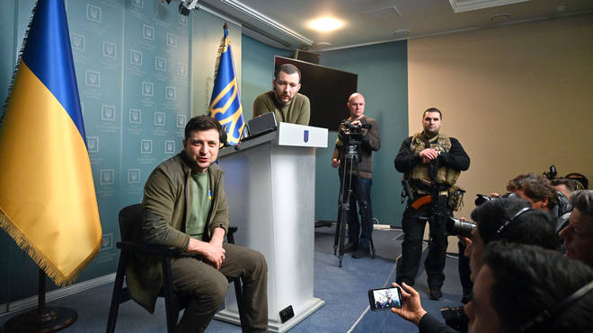 Ukrainian President Volodymyr Zelensky flanked by bodyguards at a press conference