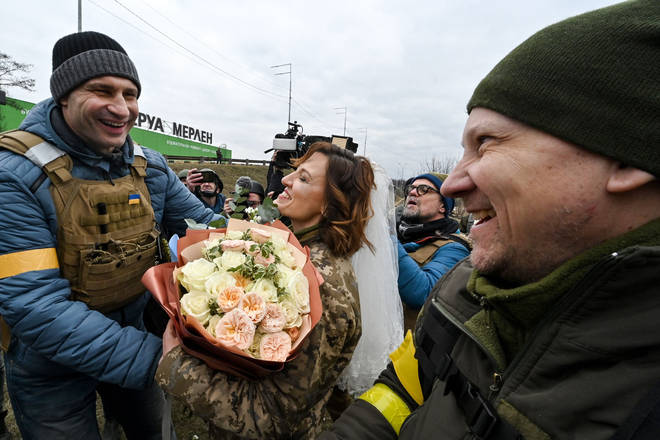 Kyiv mayor Vitali Klitschko (left) congratulates Valery (right) and Lesya (centre) after their spontaneous wedding
