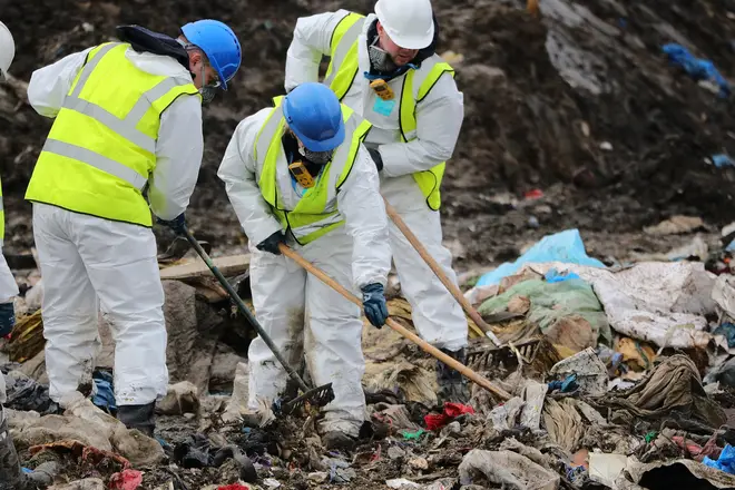 Police officers search a landfill site in Milton, near Cambridgeshire in England