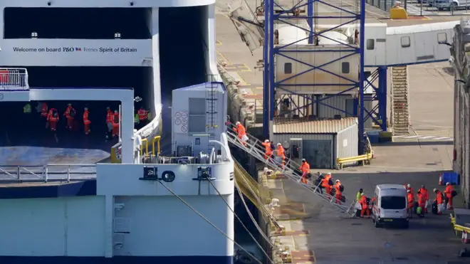 Workers carrying luggage board the P&O Ferry Spirit of Britain at the Port of Dover in Kent as the company has suspended sailings ahead of a "major announcement" but insisted it is "not going into liquidation".