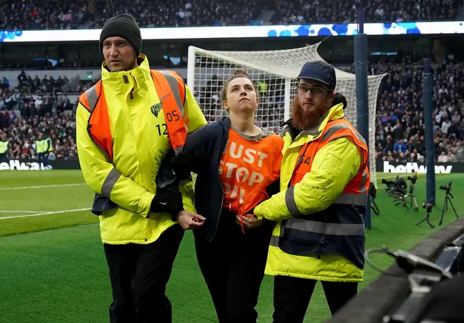 A protestor is removed by stewards during the Premier League match at the Tottenham Hotspur Stadium, London.