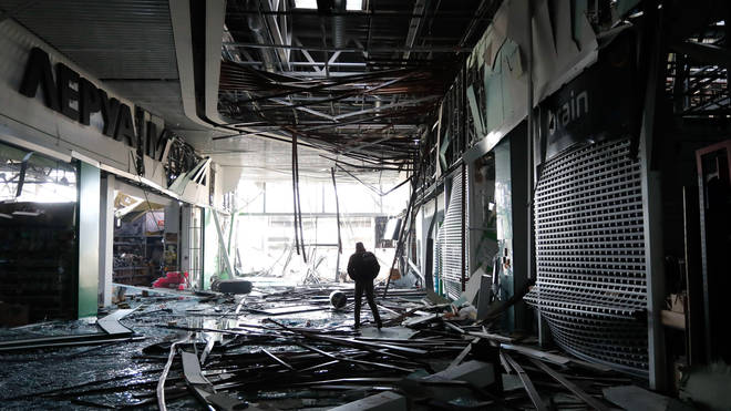 man is seen inside the damaged shopping mall
