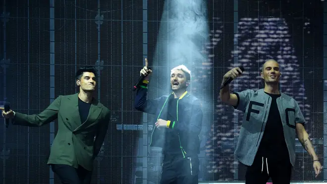 Tom performing with Max and Siva from The Wanted
