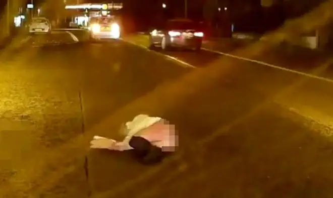 Woman left lying in road