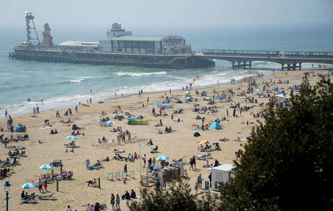 People enjoy the good weather at Bournemouth Beach in Dorset as the UK is set for another day of warm weather ahead of Easter Sunday, after experiencing the hottest day of the year so far.
