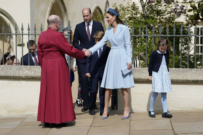 Prince William, Duke of Cambridge, Catherine, Duchess of Cambridge, Prince George and Princess Charlotte say goodbye to Dean of Windsor, The Right Revd David Conner, as they leave the Easter Matins Service
