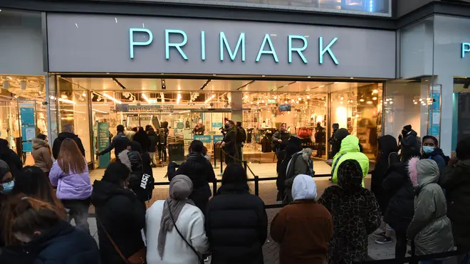 Shoppers queue outside a branch of Primark
