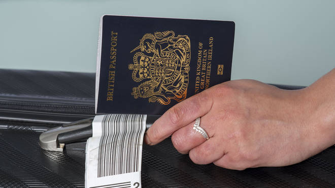 Passenger holding new UK passport in dark blue