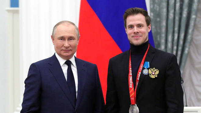 Vladimir Putin, pictured handing medals to the Winter Olympics athletes, could strike at Britain
