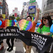 People march with rainbow-coloured and heart-shaped posters and a banner during the Tokyo Rainbow Pride parade in Tokyo’s Shibuya district in 2017