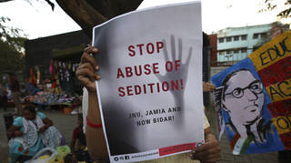 A woman holds a placard protesting against a sedition case in Bangalore, India, in 2020