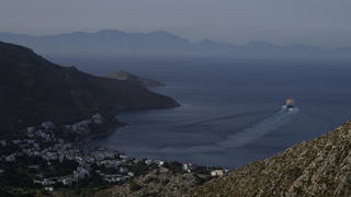A ferry departs from Livadia port on the Aegean Sea island of Tilos, south-eastern Greece