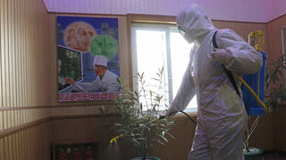 An official of the Hygienic and Anti-epidemic Center in Phyongchon District disinfect the corridor of a building in Pyongyang, North Korea