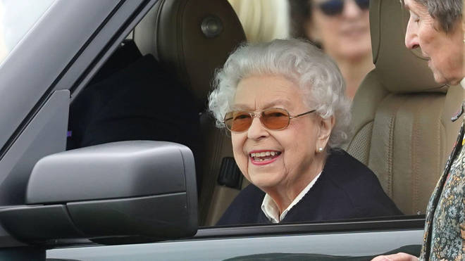 The smiling Queen was pictured talking to festival goers