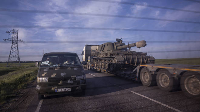 A truck transports a platform with a Ukrainian self-propelled artillery vehicle in the Donetsk region of Ukraine on Thursday May 12 2022