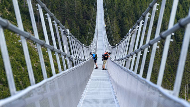 People stand on the suspension bridge a day before its official opening at a mountain resort in Dolni Morava, Czech Republic