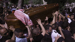Mourners carry slain Al Jazeera veteran journalist Shireen Abu Akleh to her burial in Jerusalem