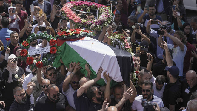 Family, friends and colleagues of slain Al Jazeera journalist Shireen Abu Akleh carry her coffin to a hospital in the east Jerusalem neighbourhood of Sheikh Jarrah, on Thursday, May 12,