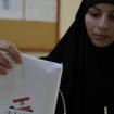 Woman places vote in ballot box