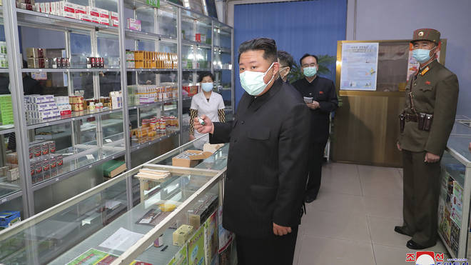 North Korean leader Kim Jong Un, centre, visits a pharmacy in Pyongyang