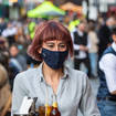 A woman dines in a face mask