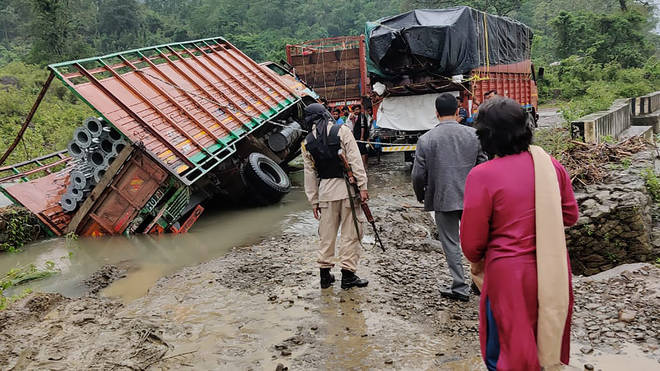 People inspect the area of a landslide after heavy rainfall in Dima Hasao district, in the northeastern Indian state of Assam (AP)