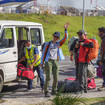 A mountaineer waves as she arrives at the airport after climbing Mount Everest