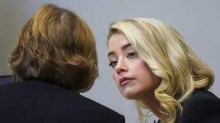 Amber Heard talks with her lawyer