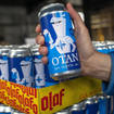 Beer cans inspired by the Nato logo by Olaf Brewing Company are displayed in Savonlinna, eastern Finland