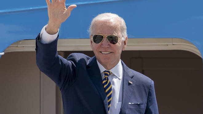 President Joe Biden waves as he boards Air Force One
