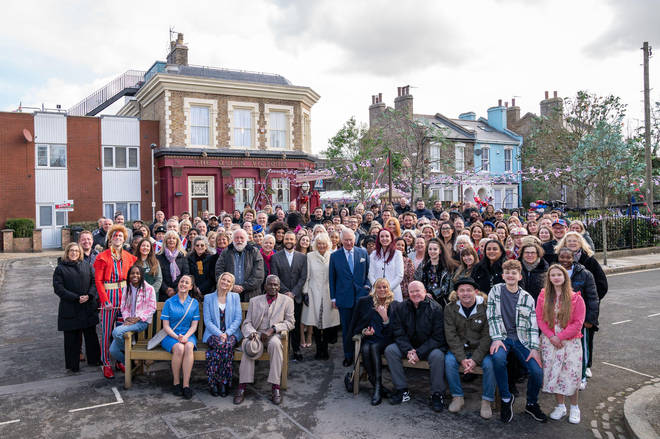 The Prince of Wales and The Duchess of Cornwall during a group photo of cast and crew during a visit to the set of EastEnders