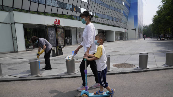 Residents pass by a quiet shopping centre area in Beijing