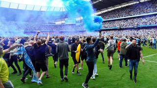 Two football fans have been charged over an incident at Manchester City's Etihad stadium on Sunday.