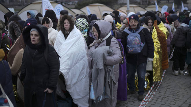 Refugees waiting for transportation after fleeing from Ukraine and arriving at the border crossing in Medyka, Poland, in March