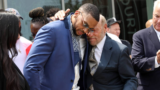 Grant Williams, left centre, is embraced by his lawyer Irving Cohen after his murder conviction is vacated