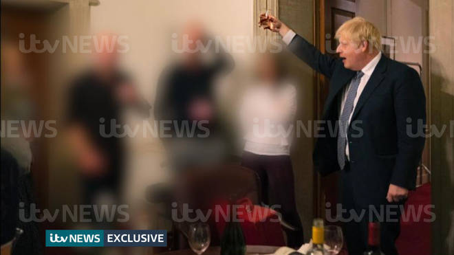 The photo shows Mr Johnson raising a glass with at least eight other people, including the photographer