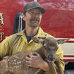 Firefighter Nate Sink cradles a newborn elk calf he encountered in a remote, fire-scarred area of the Sangre de Cristo Mountains near Mora, New Mexico