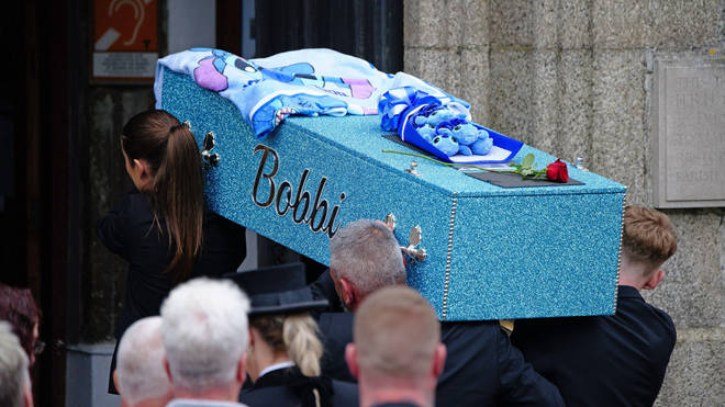 Bobbi-Anne's blue coffin was brought to church by horse and carriage