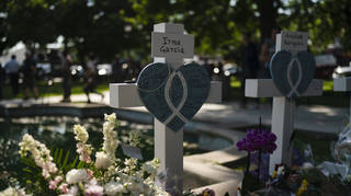 Messages are written on a cross honouring Irma Garcia, a teacher who was killed in this week's elementary school shooting, in Uvalde, Texas, Thursday