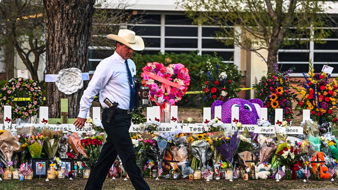 Tributes have been left at the school as officers' response to the shooter came in for criticism