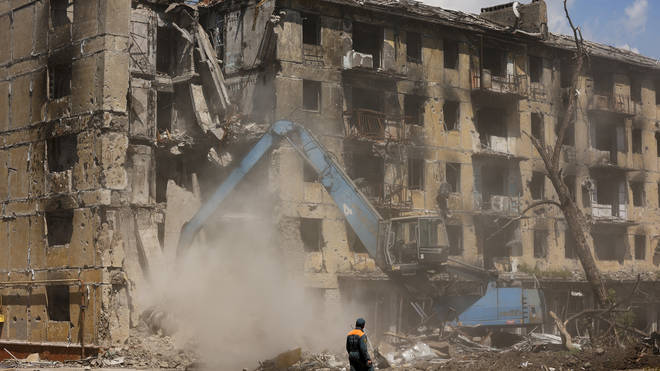 Russian Emergency Situations Ministry workers disassemble a destroyed building in Mariupol, in territory under the government of the Donetsk People’s Republic, eastern Ukraine, Friday, May 27, 2022