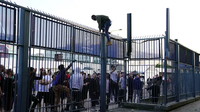 Fans waiting outside the gates to enter the stadium as kick off is delayed