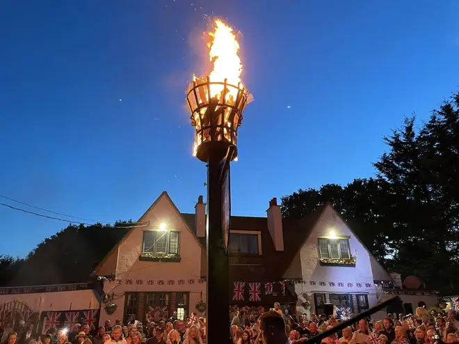 The Jubilee beacon being lit in Ramsden in Essex