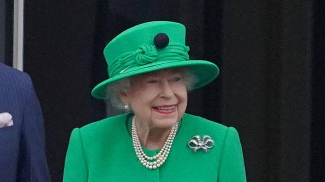 The Queen grinned as she took her place on the balcony.
