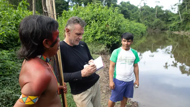Veteran foreign correspondent Dom Phillips talks to two indigenous men in Aldeia Maloca Papiú, Roraima State, Brazil, on November 16, 2019