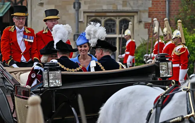 The Duchess of Cornwall, Duke of Cambridge, Duchess of Cambridge, and the Prince of Wales travel by horse-drawn carriage as they leave St George's Chapel after attending the Most Noble Order of the Garter Ceremony in Windsor Castle.