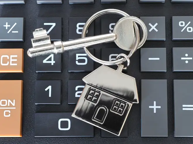 House keys resting on a calculator