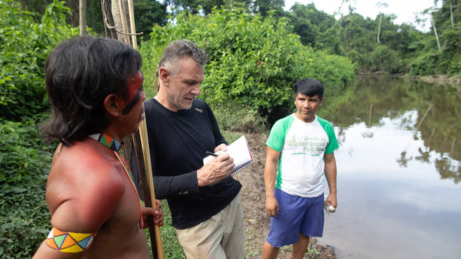 Dom Phillips talking to two indigenous men in Aldeia Maloca Papiú, Brazil, in November 2019