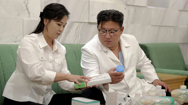 North Korean leader Kim Jong Un and his wife Ri Sol Ju prepare medicines